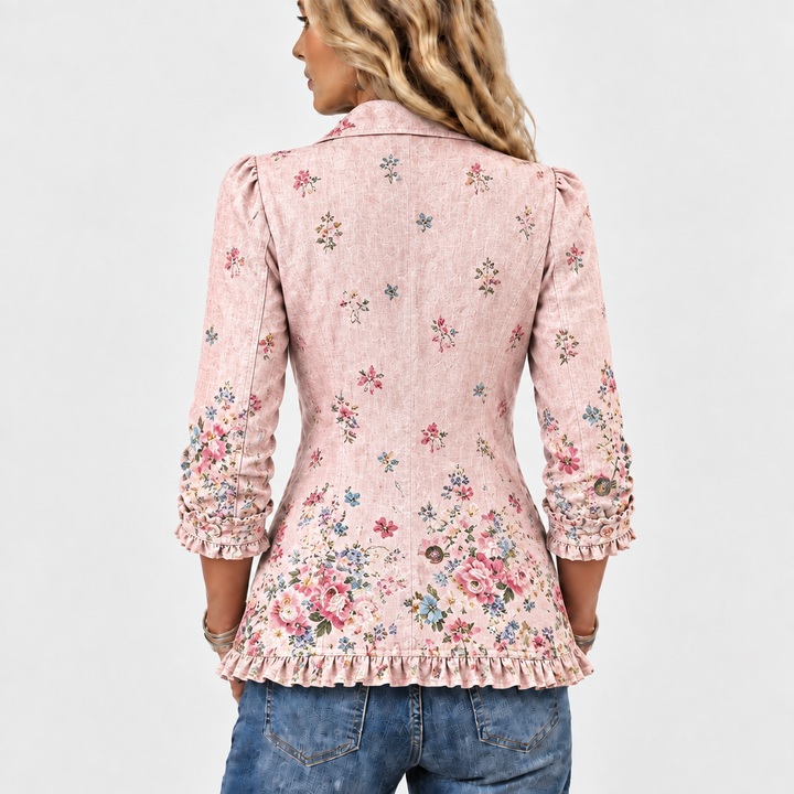 Back view of the pink floral jacket, showing scattered flowers, a ruffled hem, and ruffled sleeve cuffs 5