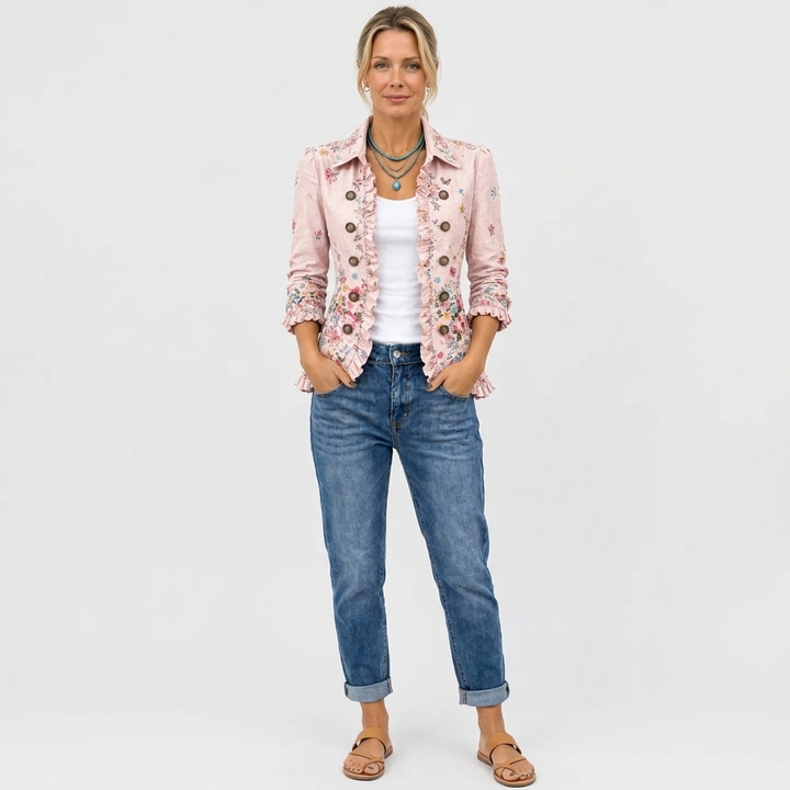 Full-length view of a model in the pink floral jacket, cuffed jeans, and tan sandals 4