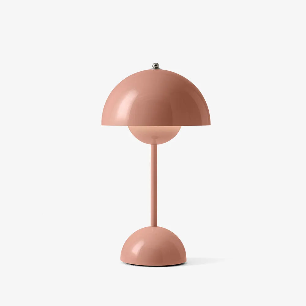 Dusty pink rechargeable USB table lamp with a thin stem and half-sphere base against a plain white background.