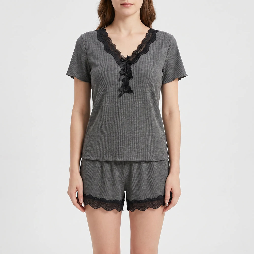 Front view on a model in the gray ribbed pajama top with black lace V-neckline, three small black bows, and shorts with black lace hems. 2