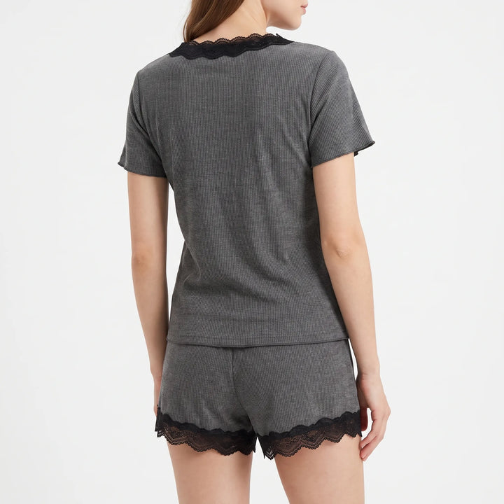 Back view on a model showing the plain gray ribbed top with black lace trim at the neckline and lace-trimmed hems on the shorts. 3