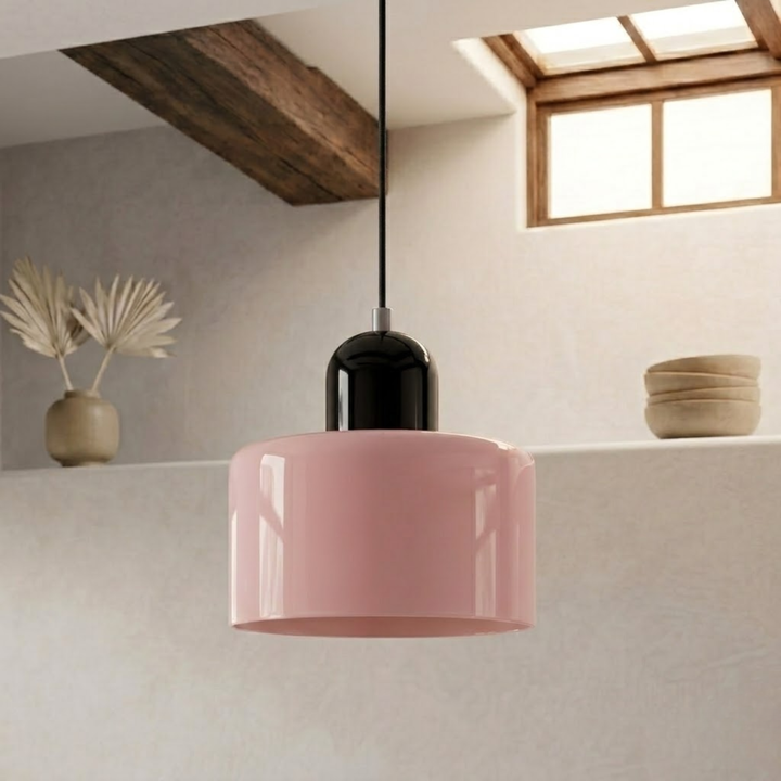 Pink drum shade topped with a black glossy cap, hanging from a black cord in a room with a timber beam. 4