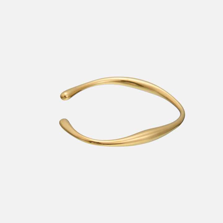 Lysa Gold Bracelet detail with a side view of the flowing curved gold cuff