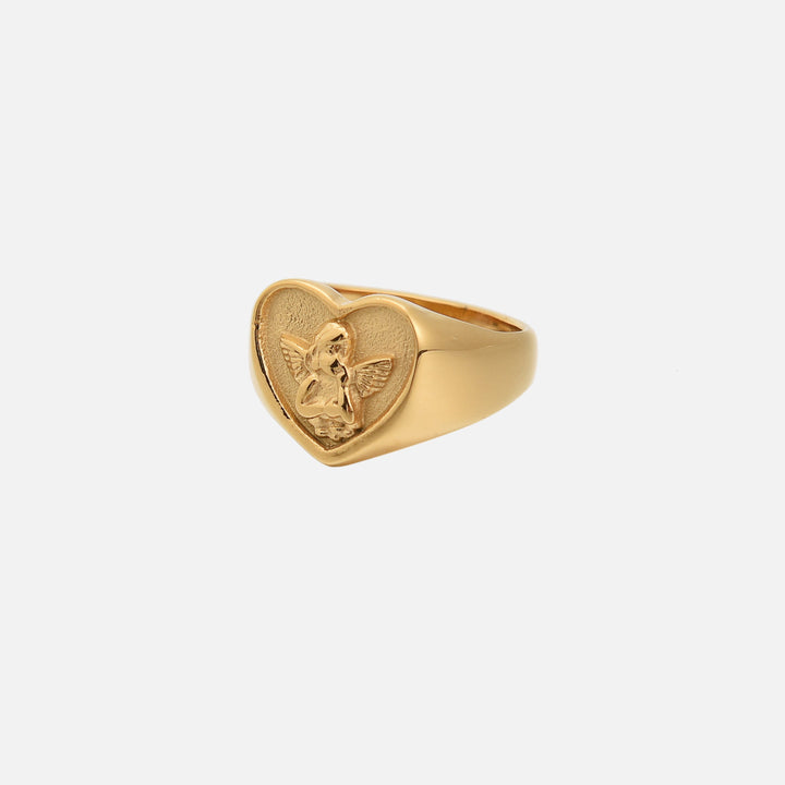 Gold-tone heart signet ring with a raised cherub in relief, shown from the front at an angle 1