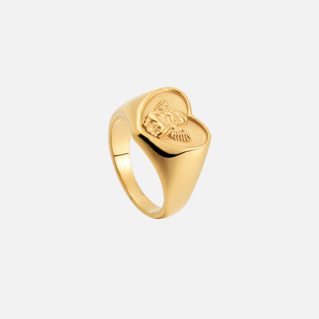 Same gold heart ring tilted to show the cherub relief and the smooth, polished band 2