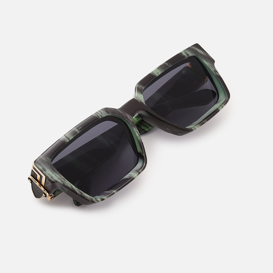 Folded green and black marbled sunglasses with gold hinge, viewed from above at an angle. 16