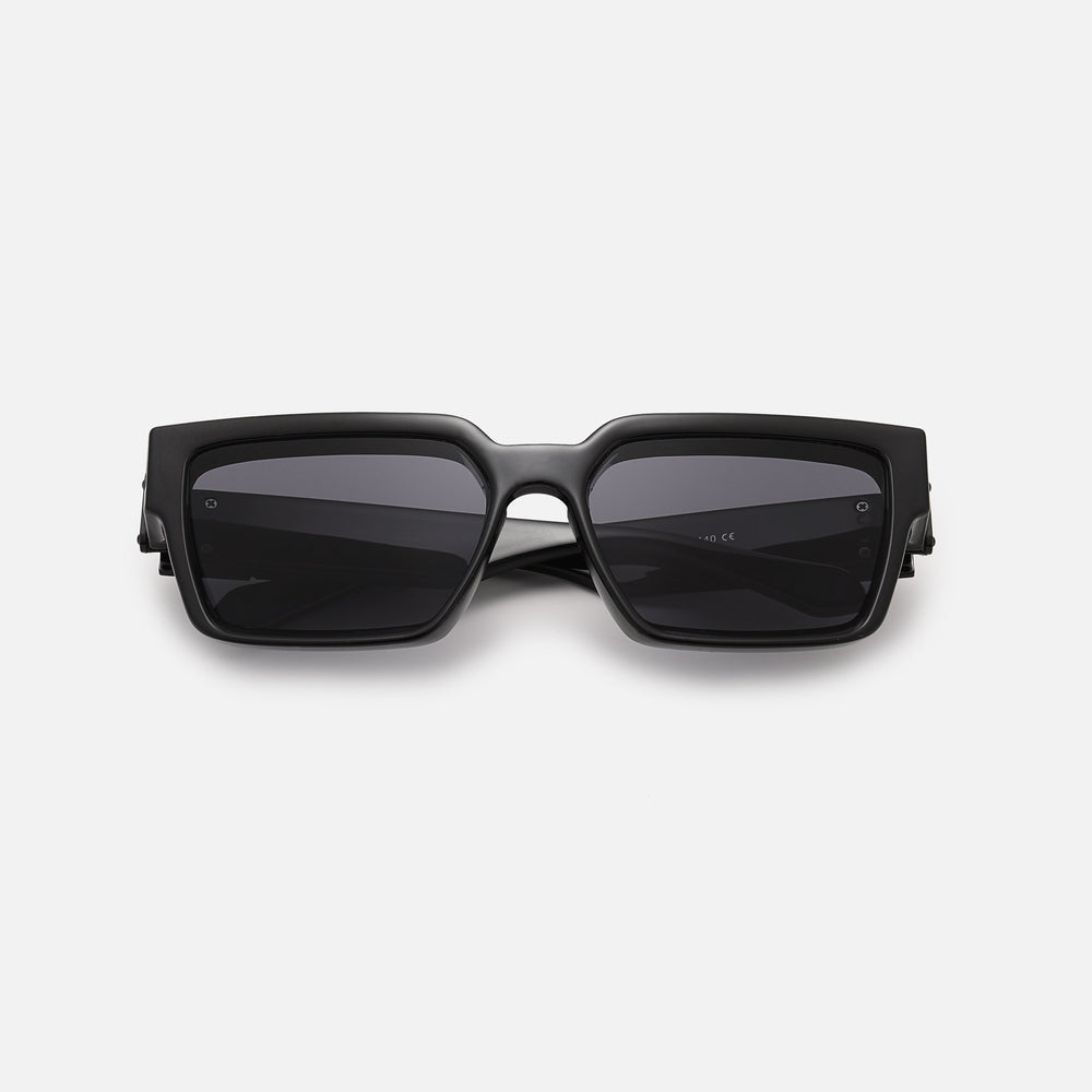 Black square sunglasses with dark lenses, folded and lying flat, seen from the front. 2