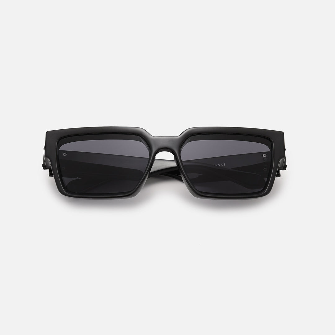 Black square sunglasses with dark lenses, folded and lying flat, seen from the front. 2