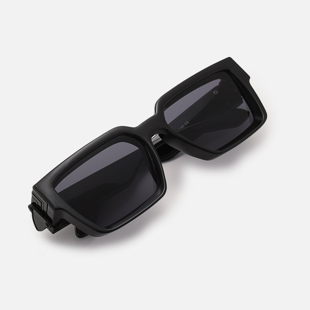 Folded black sunglasses with dark lenses, viewed from above at an angle, showing the hinge plate. 3