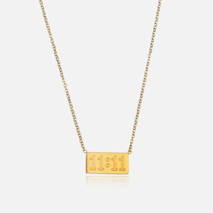 Lucky Elevens Necklace in gold with a thin chain and small rectangular pendant shown straight on.