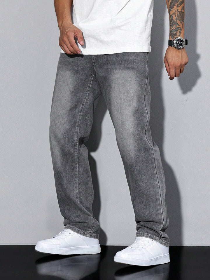 Front view of washed gray jeans on a standing model with arms relaxed at his sides 4