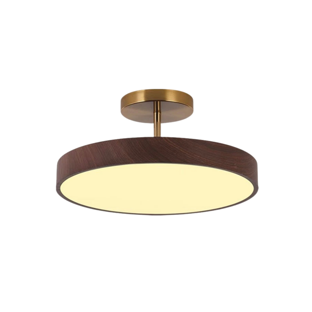 Dark wood-look disc ceiling light with brass-tone mount and stem, lit with a warm glow, shown alone on a white background.