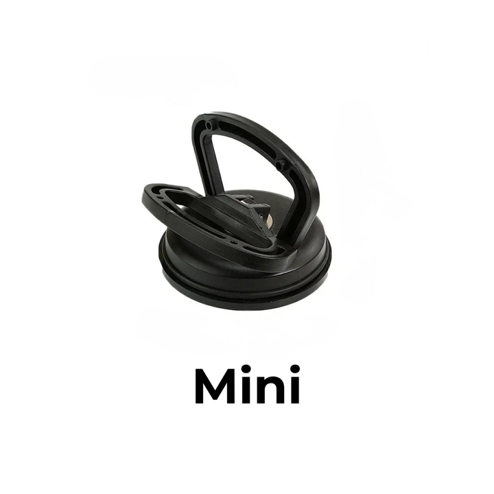 Small black suction cup dent puller with a folding handle and a wide black rubber rim on a white background.