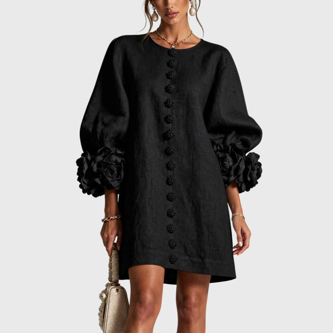 Black linen mini dress with puff sleeves and flower buttons, front view.