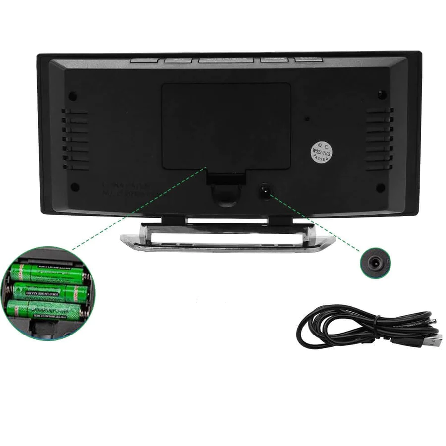 Back of the clock showing the battery compartment with batteries, the power socket and a black USB charging cable.