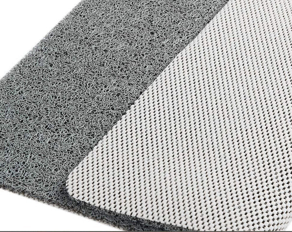Close-up detail of the gray looped top surface next to the white perforated non-slip backing, folded back at one corner. 4