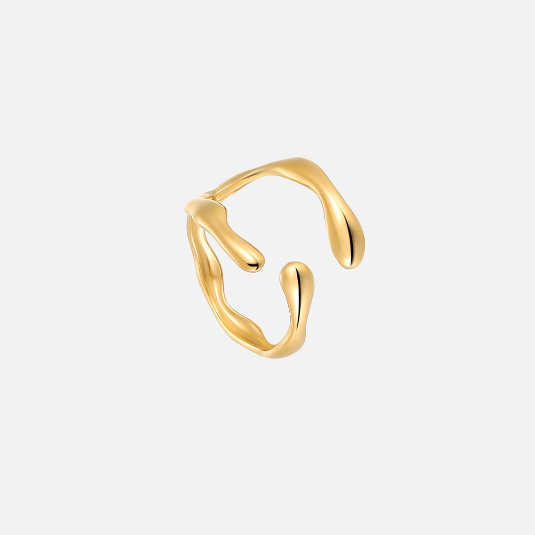 Gold-toned open ring with a flowing, wavy band and rounded drop-shaped ends, shown at an angle on a plain light background. 1