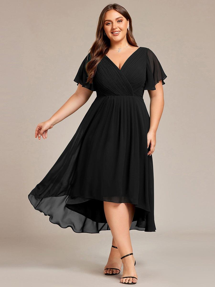 Plus-size model in the black chiffon dress with flutter sleeves, skirt swinging out to show the sheer high-low hem. 26