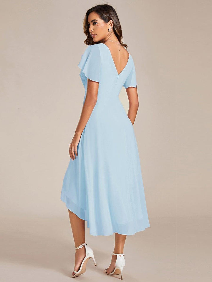 Back view of the light blue chiffon dress showing the deep V back, hidden zipper and uneven high-low hemline. 85