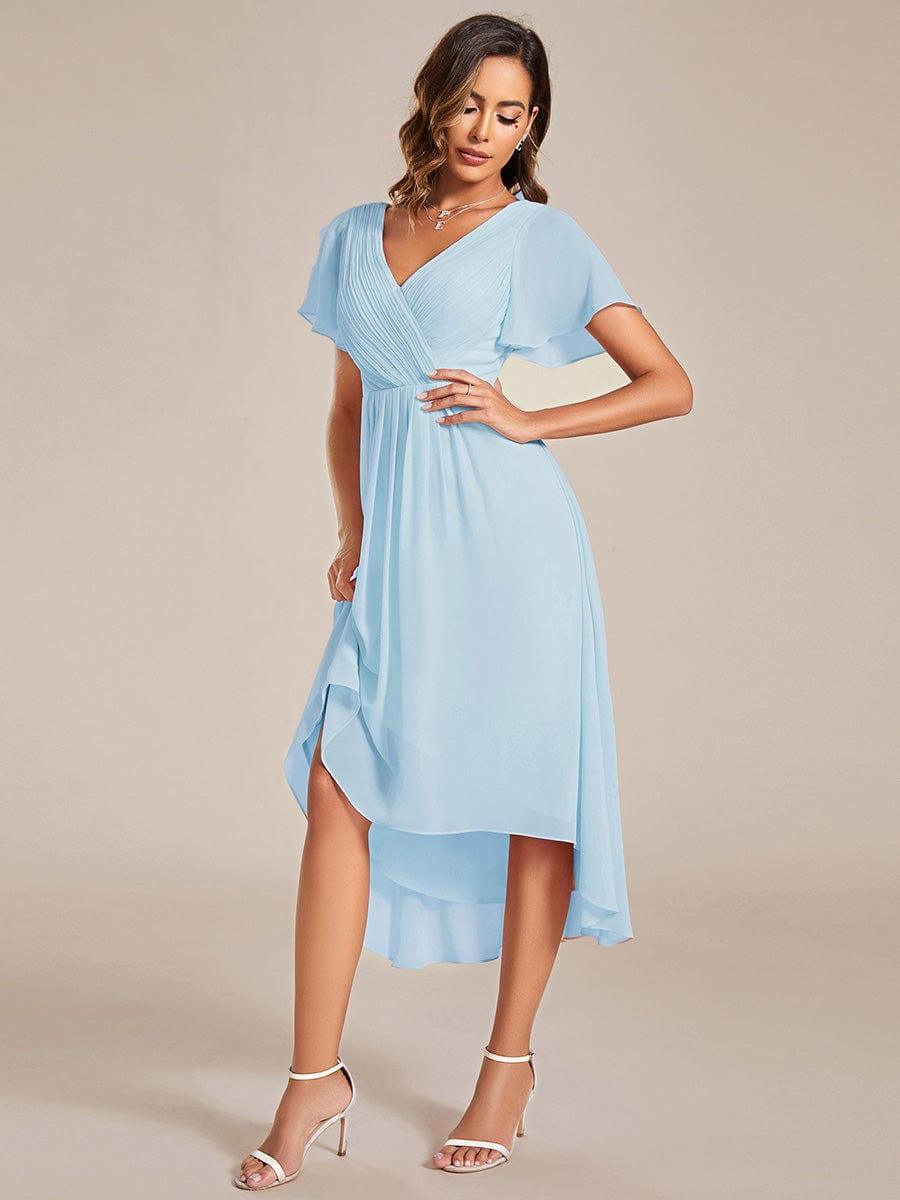 Side view of the light blue chiffon dress with one hand on hip, showing the skirt's asymmetric high-low drape. 88