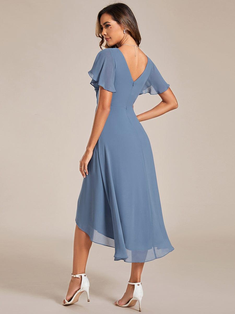Back view of the dusty blue dress showing the V-shaped back, zipper and asymmetrical chiffon hem. 6