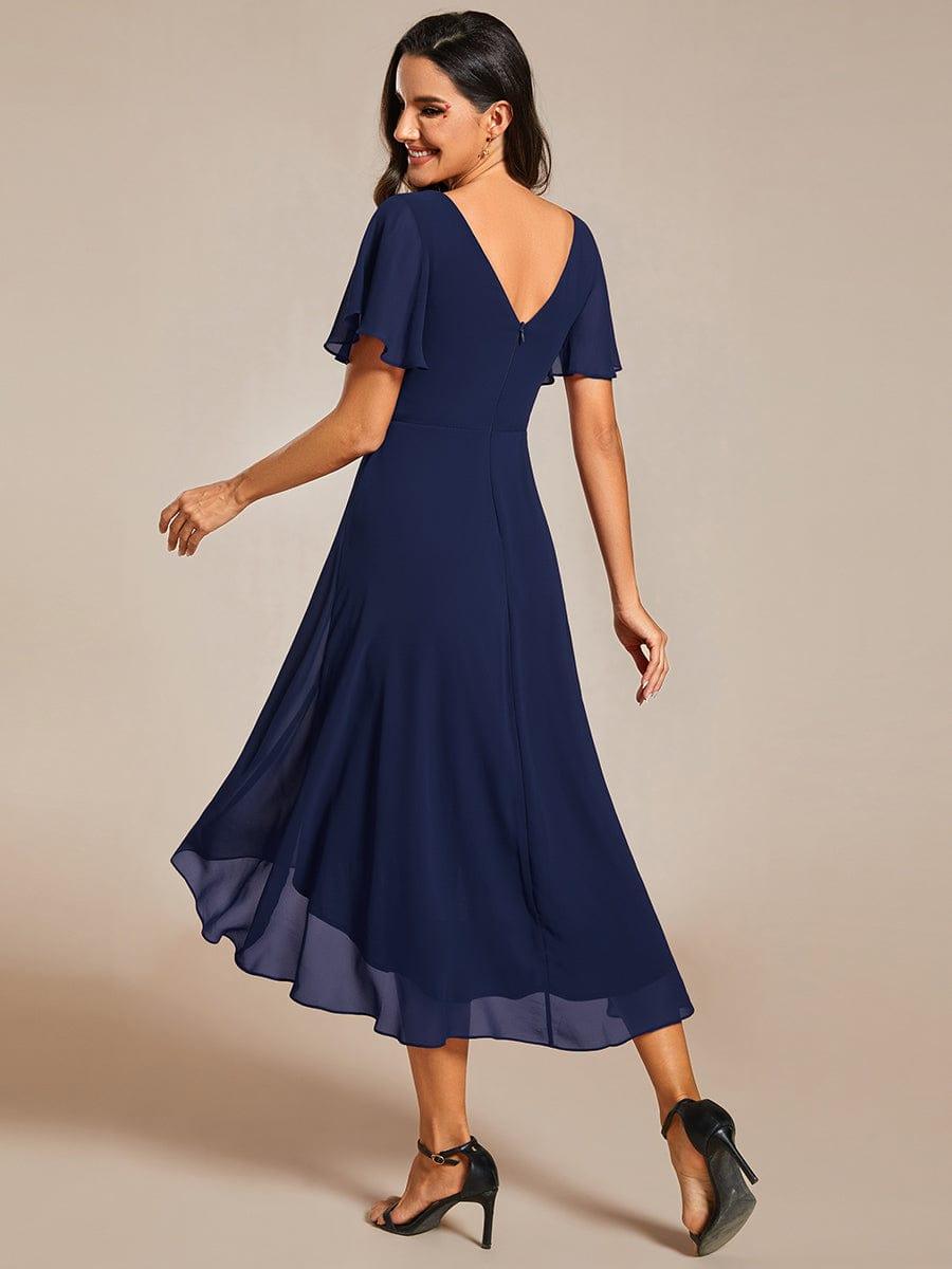 Back view of the navy chiffon dress showing the deep V back, center zipper and flowing high-low hem. 2