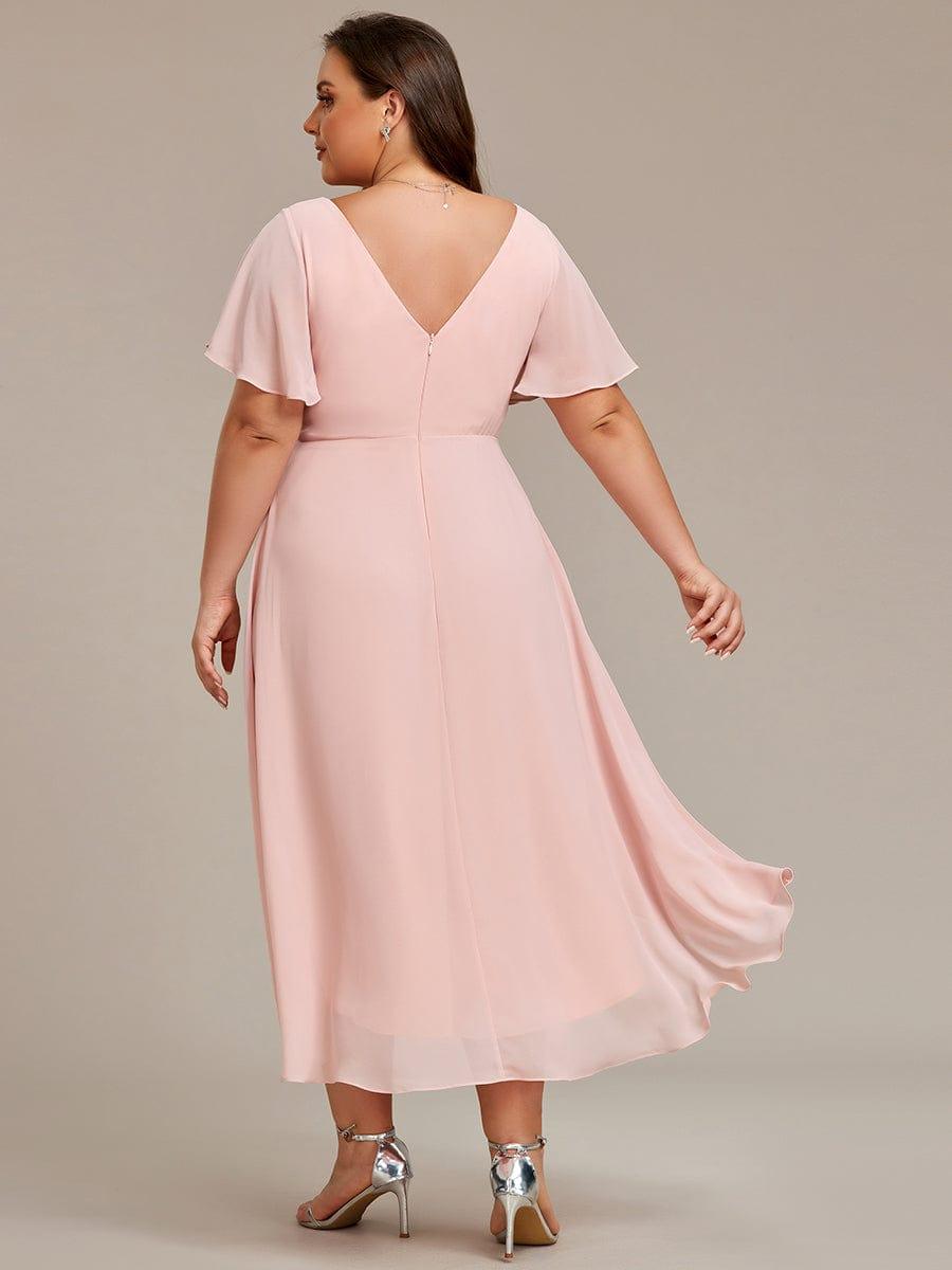 Back view of a plus-size model in the pink chiffon dress, showing the V back, center zipper and trailing hem. 32