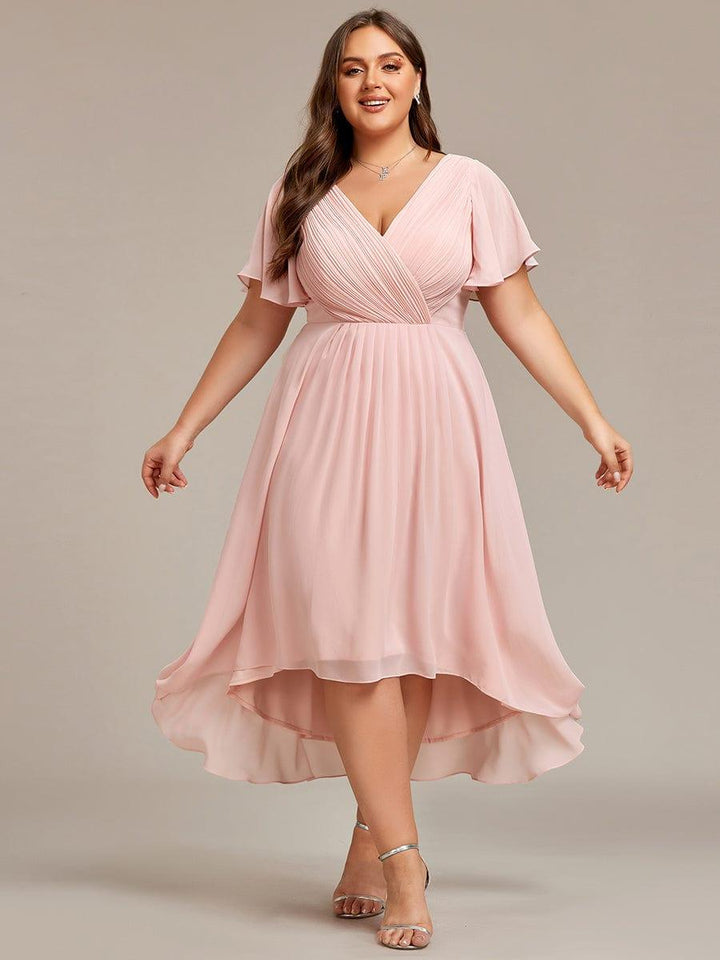 Plus-size model in the pink dress with arms out to the sides, showing the full flowing skirt and curved hem. 35