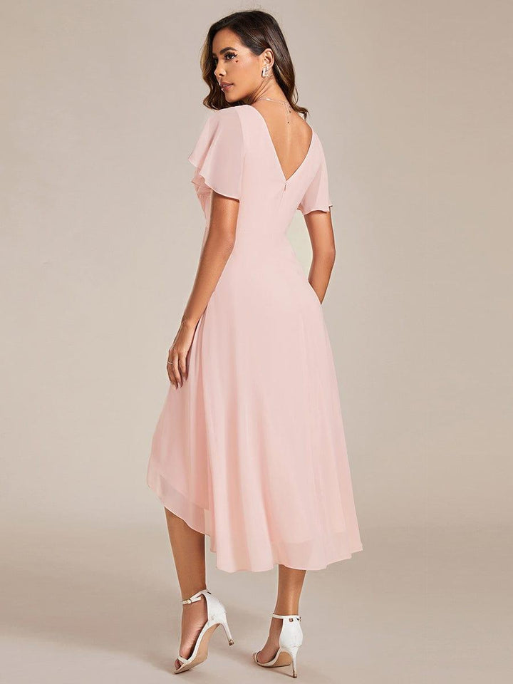 Back view of the pink chiffon dress showing the deep V back with zipper and high-low hem. 16