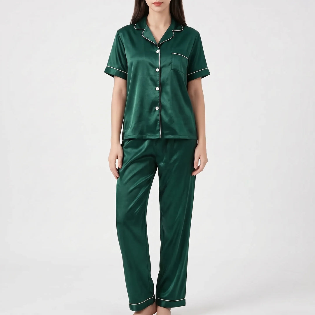 Woman in the dark green satin version of the pajama set with white piping, shown from the front. 9