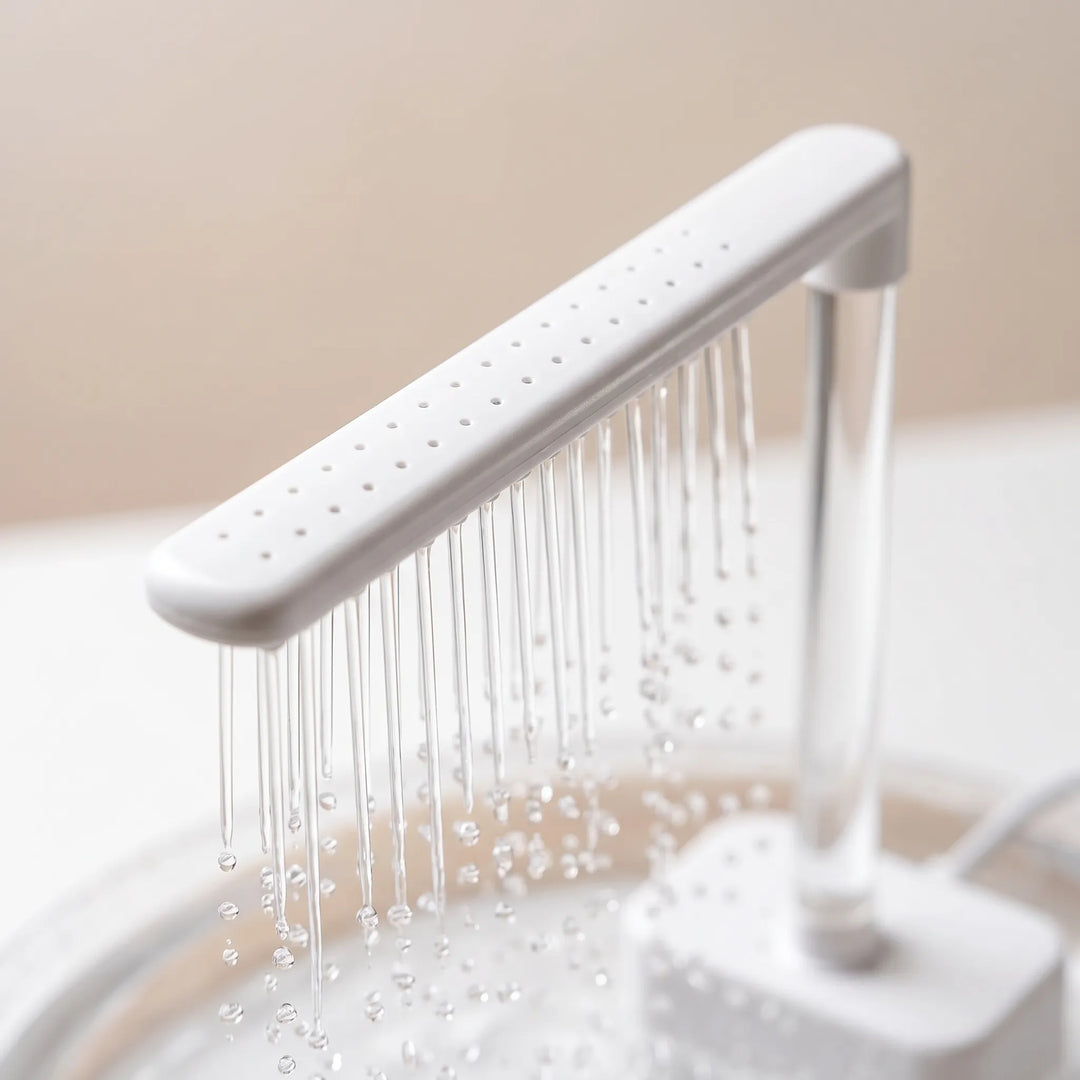 Close-up of the white shower arm with rows of small holes, thin streams of water and droplets falling from it. 3