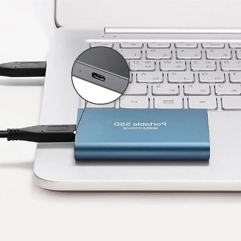 Blue drive plugged into a laptop with a circular close-up inset highlighting its USB-C port.