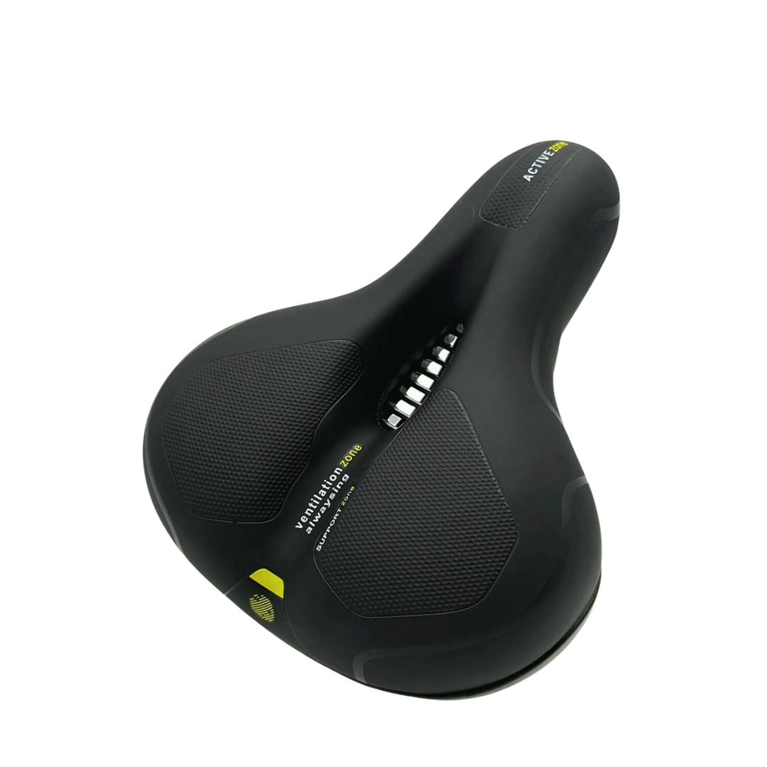 Black bike saddle seen from above at an angle, with textured grip pads, a central ventilation channel and yellow-green accents. 22