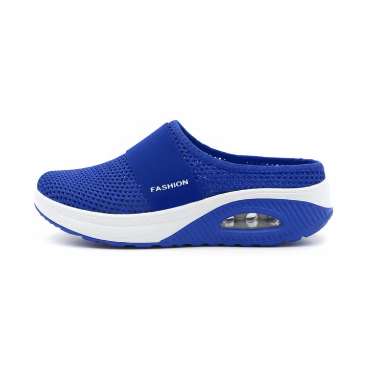 Side view of a single royal blue mesh mule showing the elastic strap, white midsole and air cushion.
