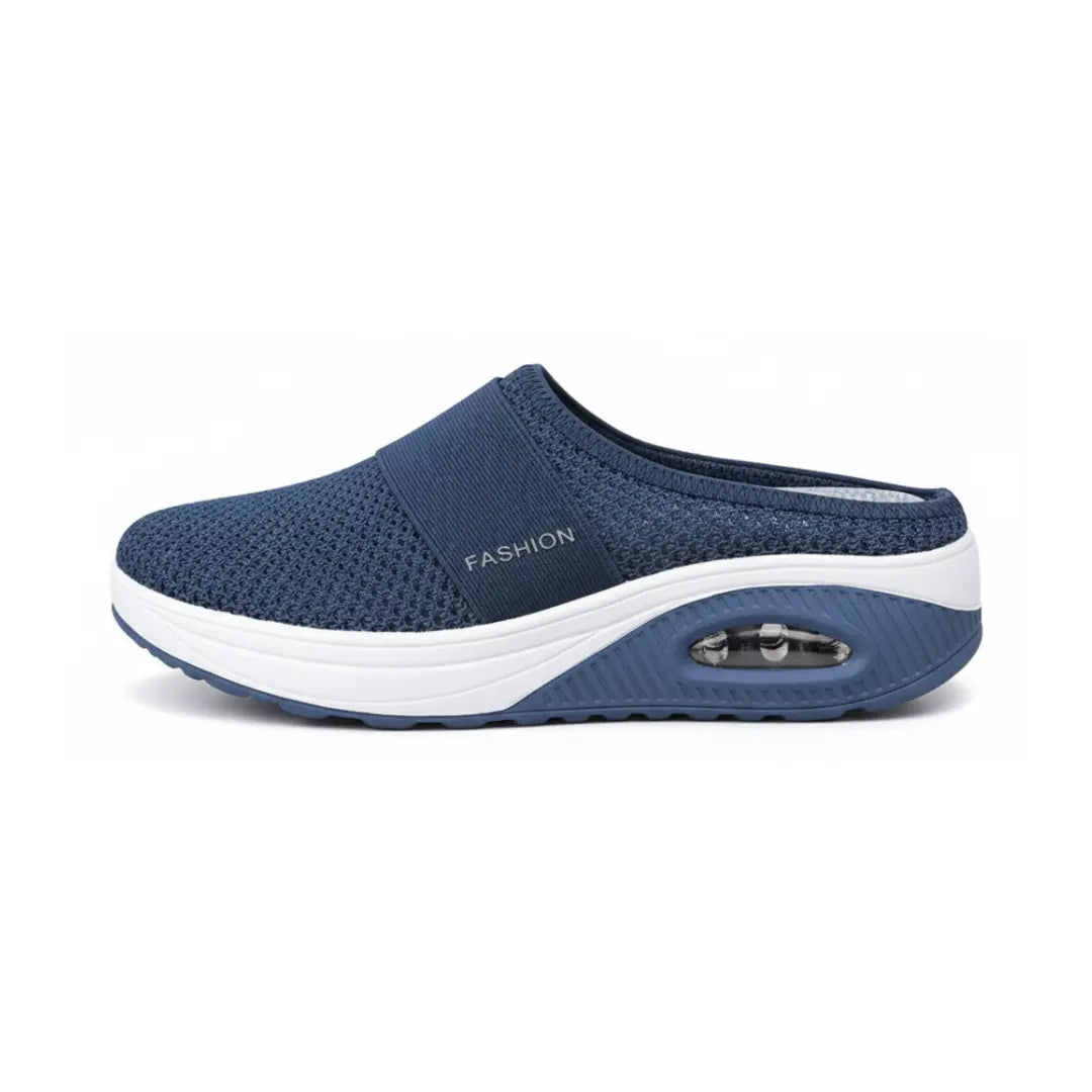 Side view of a single navy blue mesh mule with white midsole and air cushion in the heel.