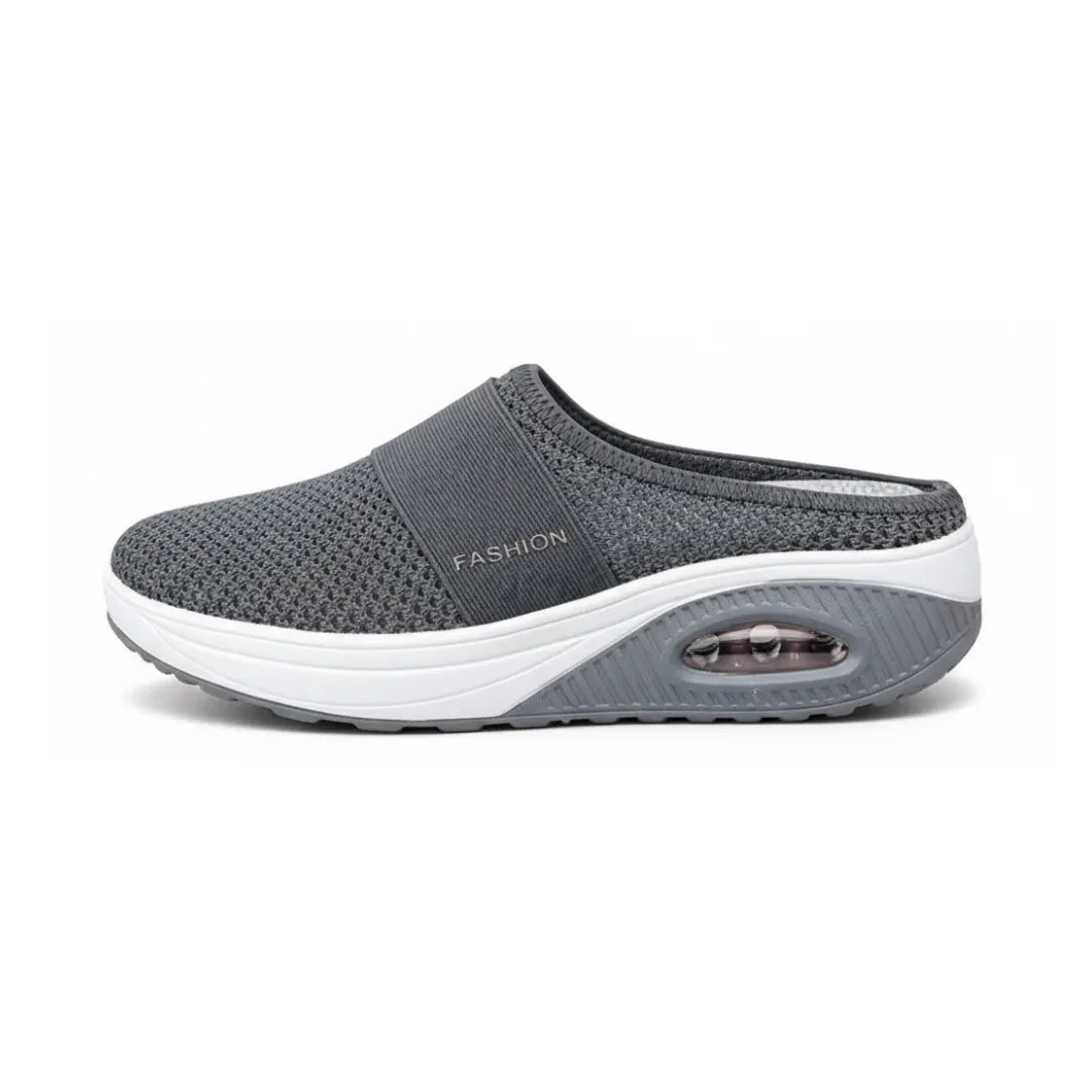 Side view of a single dark gray mesh mule with white midsole and visible air cushion in the heel.