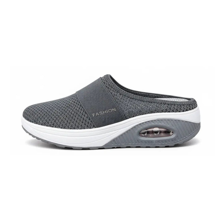 Side view of a single dark gray mesh mule with white midsole and visible air cushion in the heel.
