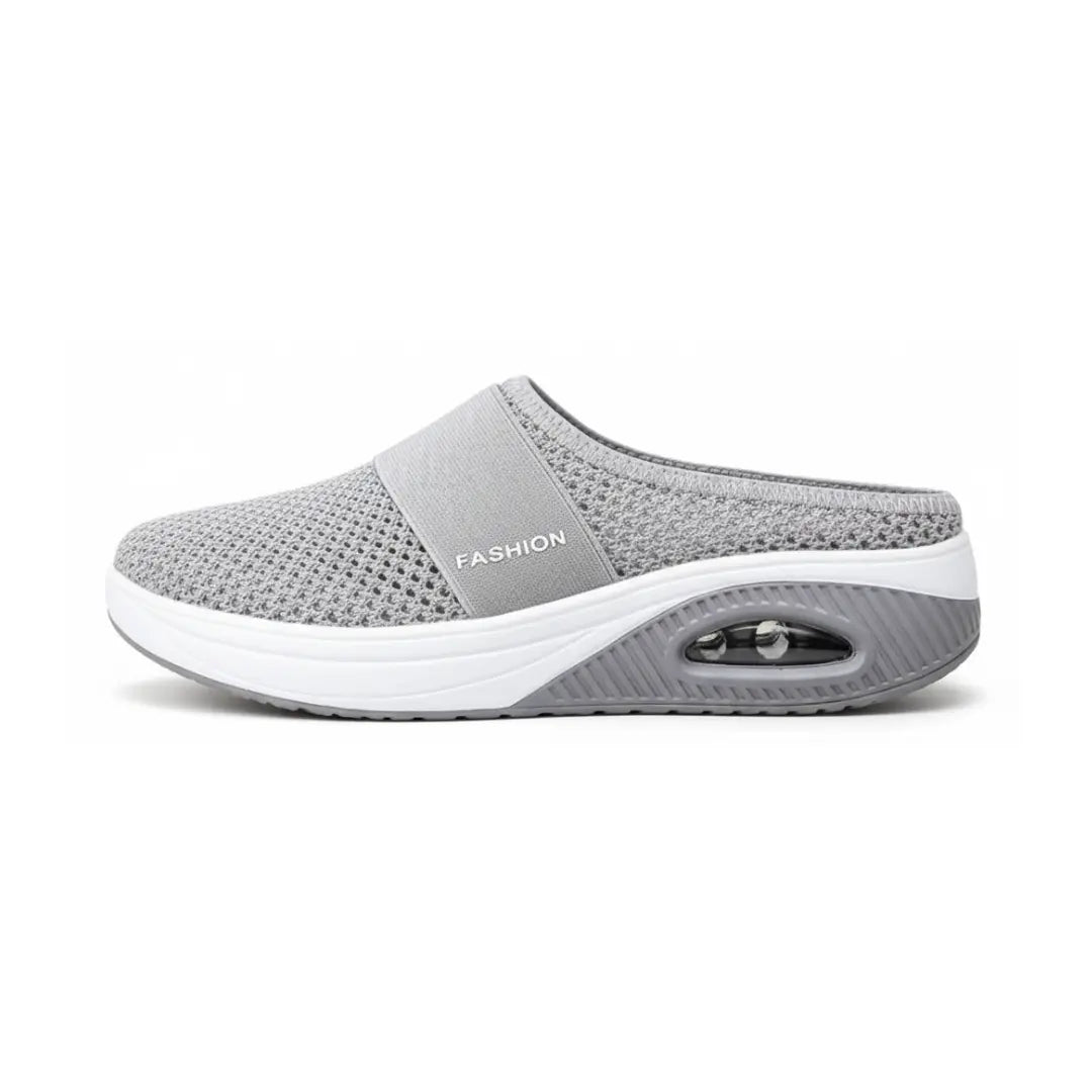 Side view of a single light gray mesh mule showing the strap, white midsole and air cushion heel.