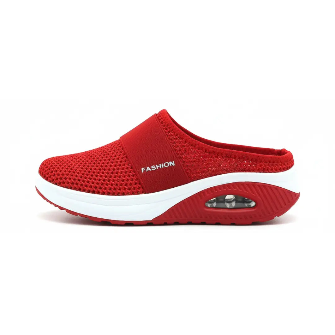 Side view of a single red mesh mule with white midsole and visible air cushion in the heel.