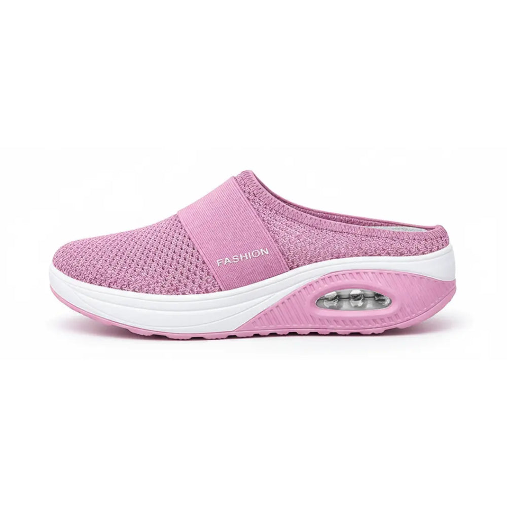 Side view of a single pink mesh mule showing the elastic strap, white midsole and air cushion in the heel.