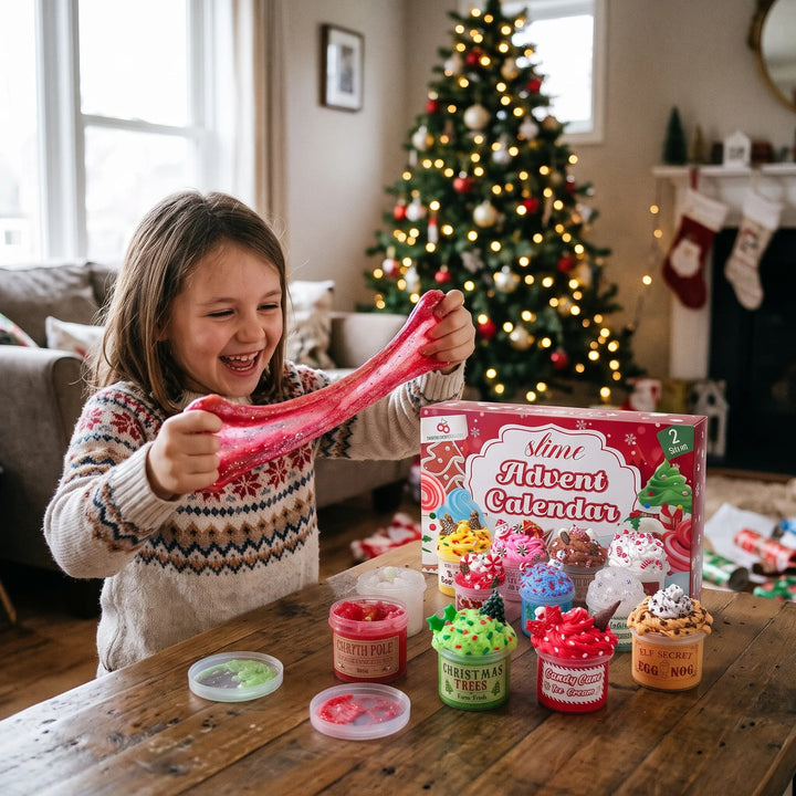 Smiling girl in a holiday sweater stretches red glitter slime beside the gift box and open slime pots 1