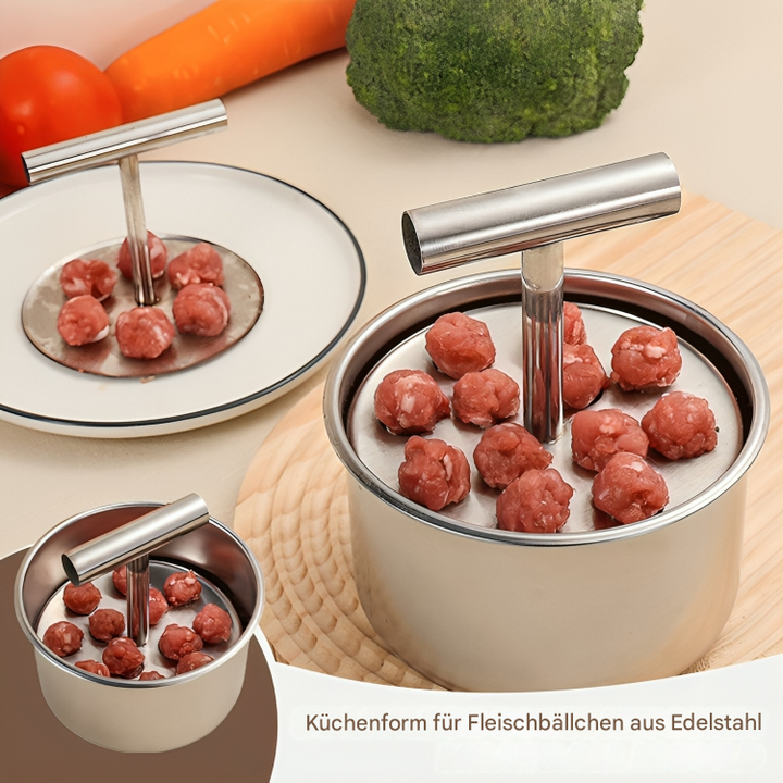 Stainless steel meatball shaper with raw meatballs in the cup and on the pressing plate, beside vegetables. 1