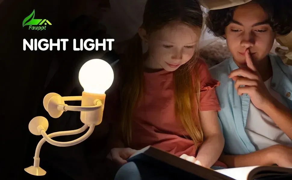 Glowing bulb-headed figure lamp with suction-cup limbs beside two children reading a book in the dark 21