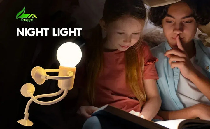Glowing bulb-headed figure lamp with suction-cup limbs beside two children reading a book in the dark 21