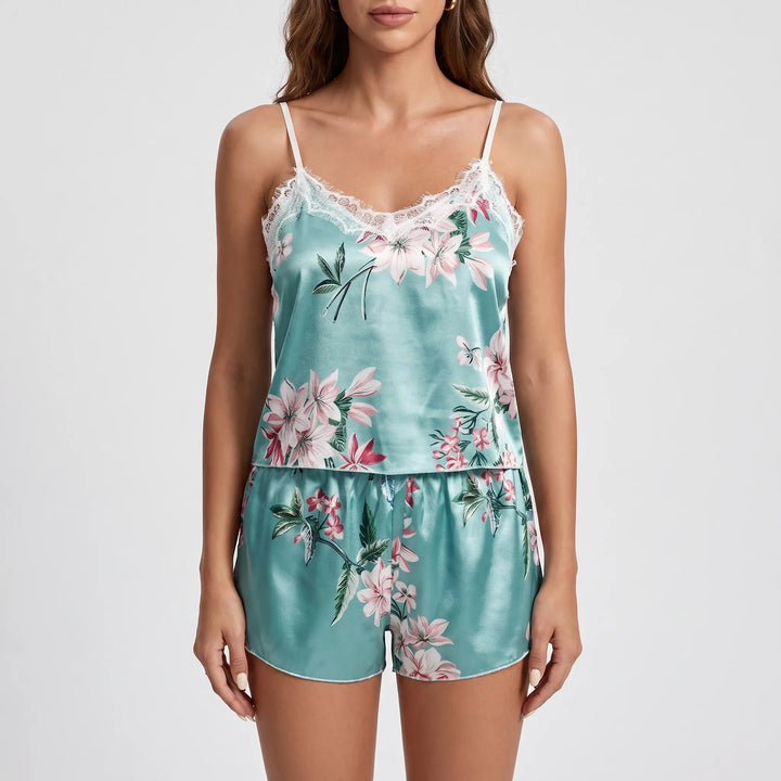 Front view of the aqua floral satin cami and shorts on a model against a light gray backdrop, hands relaxed at sides. 6