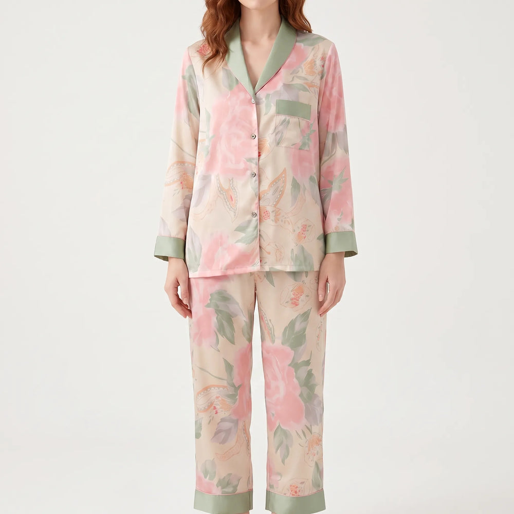 Front view on a model: pink peony print button-up top with green shawl collar and pocket, plus matching cropped pants. 2