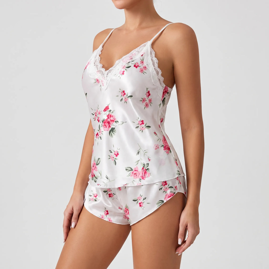 Side angle of the white satin pajama set on a model, showing lace-edged V-neck, thin straps and the scalloped shorts hem. 4