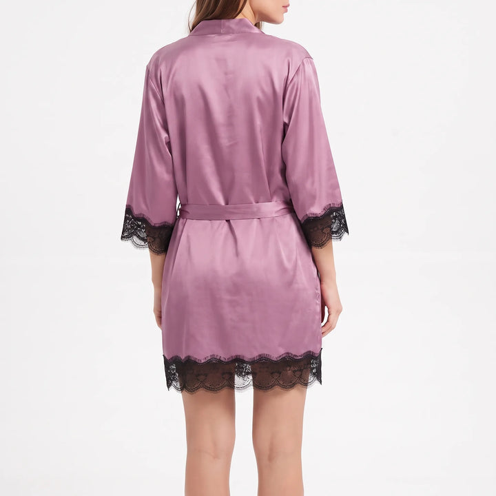 Back view of the mauve satin robe with belt at the waist and black lace trim on sleeves and hem. 2