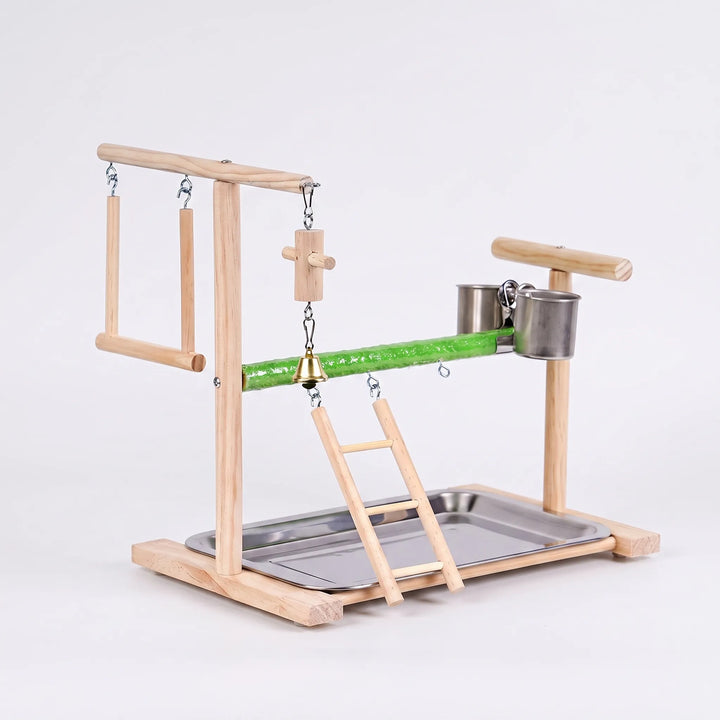 Wooden bird play stand from the opposite angle, showing the swing on the left, hanging bell toy, ladder, steel cups and tray. 4