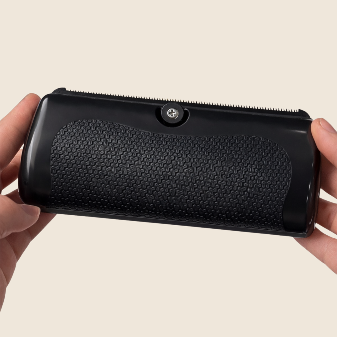 Detail of the black brush showing the textured, non-slip grip, screw knob and fine toothed edge.